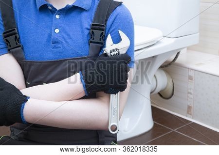 Plumbing Repairs. The Master Came Home And Is Engaged In Plumbing Repairs.