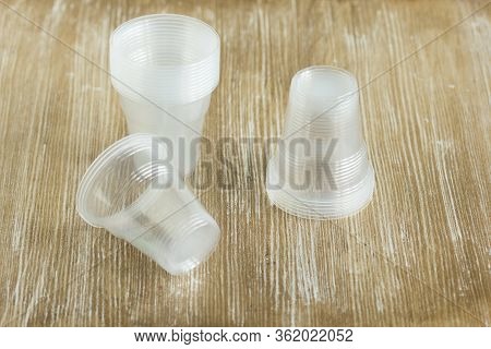 Stack Empty Plastic Glasses Of One Hundred Milliliters For Seedlings And Rooting Cuttings On Wooden 