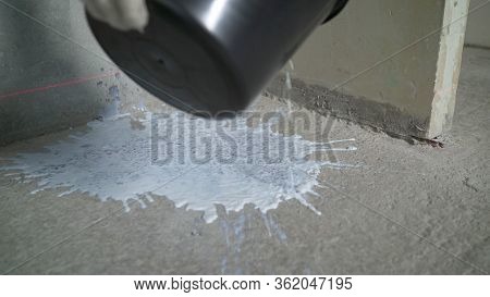 The Roller Is Wetted In A Liquid Primer In A Plastic Black Container, Before Painting The Walls With
