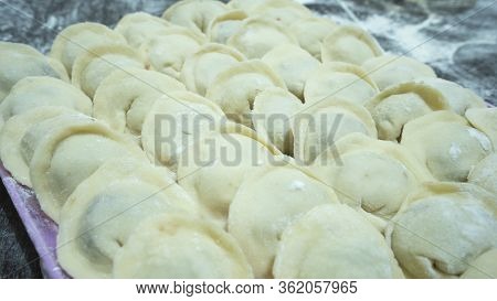 Meat Dumplings - Russian Pelmeni On Wooden Background