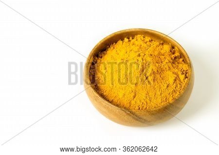 Turmeric Powder In Wooden Bowl On The White Background Isolated Closeup. Health Care Concept. Altern