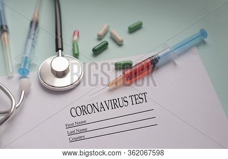 A Syringe With A Blood Test And A Stethophonendoscope With A Patient Questionnaire And Tablets For A