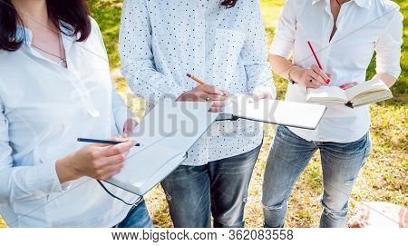Young Beautiful Girls Drawing The Pictures In Sketchbook.