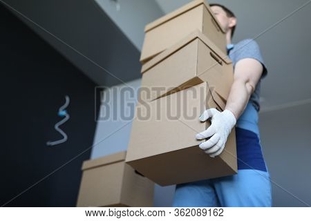 Loader Man Carries Cardboard Boxes In Office. Company Provides Freight Transport At Appointed Time, 