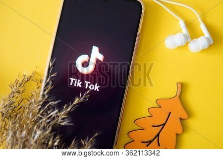 Tver, Russia-april 9, 2020, The Tik Tok Logo On A Smartphone Screen On An Yellow Background With Hea