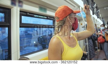 Woman Travel Caucasian Ride At Overground Train Airtrain With Wearing Protective Medical Mask. Girl 