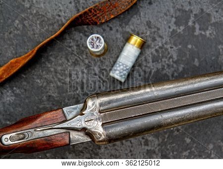 Old Classic Double-barreled Hunting Rifle Of The Twelfth Caliber And Cartridges For It On A Dark Bac