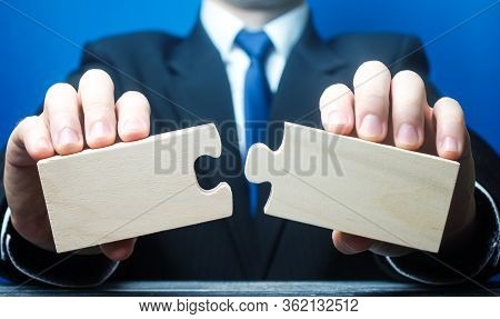 Businessman Holds In Hands Two Empty Pieces Of The Puzzle. Business Management, Planning Strategy. T