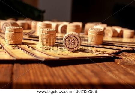 Family Vintage Interesting Game, Bingo Cards And Bingo Balls Lie On A Wooden Table