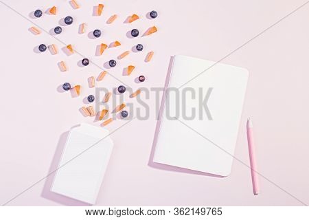 Vitamins And Supplements For Healthy Eyes On Pink Background. Blueberry, Carrot Pieces And Orange Ca