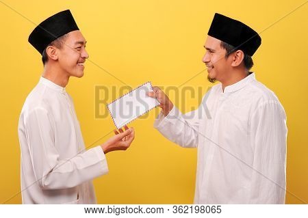 Young Asian Muslim Man Give Alms To Other Muslim On Ramadan Kareem. It's The Best Time To Give Alms 