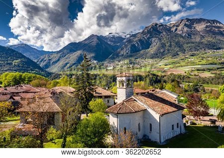 Aerial View Of Valley With Church In Cares, Trentino, Green Slopes Of The Mountains Of Italy, Huge C