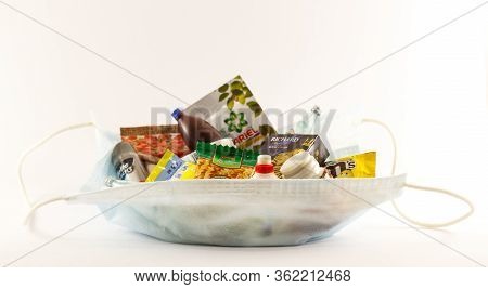 Toy Set Products And Household Goods Of Different Brands In A Medical Mask On A White Background