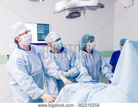 Arthroscope Surgery. Orthopedic Surgeons In Teamwork In The Operating Room