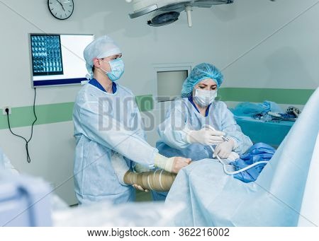 Arthroscope Surgery. Orthopedic Surgeons In Teamwork In The Operating Room