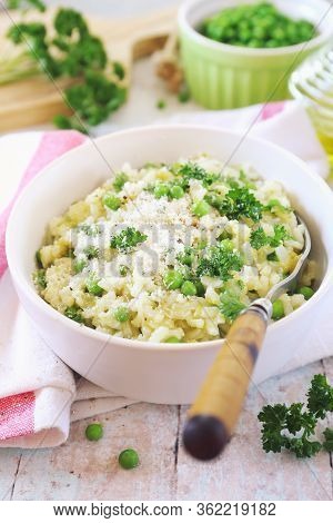 Italian Cuisine. Risi E Bisi, Venetian Cuisine.  Plate Of Green Pea Risotto With Green Pea, Grated P