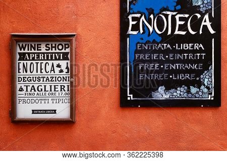 Neive, Italy - March 3, 2019: Wine Shop's Signs Over The Walls Of Neive, Italy, On March 3, 2019, Wi