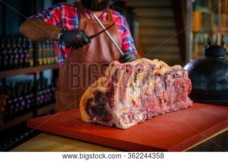 Chef cutting beef carcass in a restaurant