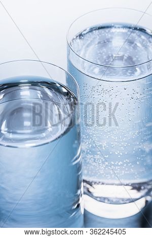 Close-up Of Glasses With Mineral And Tonic Water On A Blue Table. Mineral Water And Tonic Water Glas