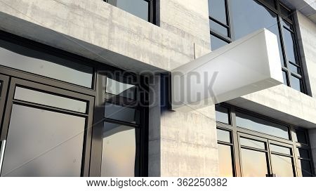 A Frameless Rectangular Lightbox Sign Mounted Outside A Generic Unbranded Shop Facade On The High St
