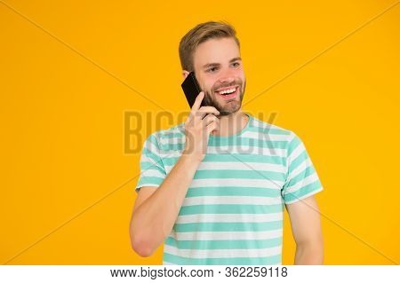 Importance Of Being Communicative. Happy Man Talk On Mobile Phone Yellow Background. Verbal Communic