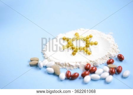 Vitamin D Yellow Pills In The Shape Of Sun On White Lecitin Powder In Sky Blue Background, Nutrition