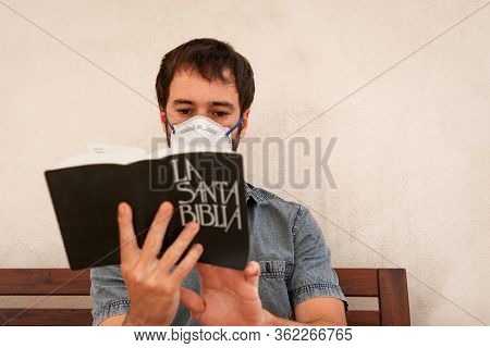 Young Man Reading And Searching For Answers In The Holy Bible During The Quarantine Of The 2019-covi