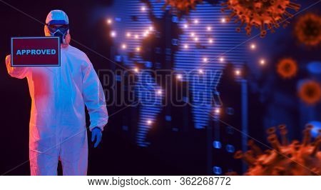 COVID-19 concept. A doctor in a protective suit holds a sign approved on the background of a coronavirus spreading around the world. Copy space.