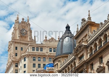 MADRID, SPAIN - MAY 13, 2018: Telefonica Building rise above historical buildings on Gran Via business district.