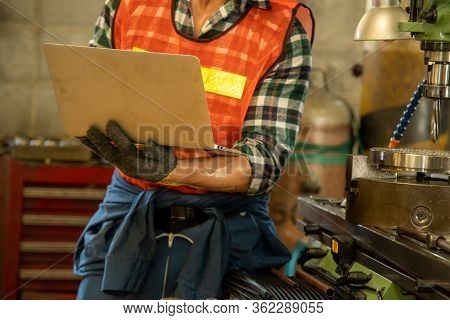 Mechanical Engineering Using A Laptop Computer With Checking Machine In Factory.heavy Industrial Wor