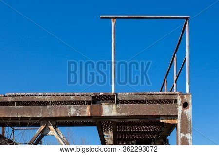 Part Of A Plant For Extraction Of Gravel. Rusted Construction, Creating A Stage With A Railing. Brig