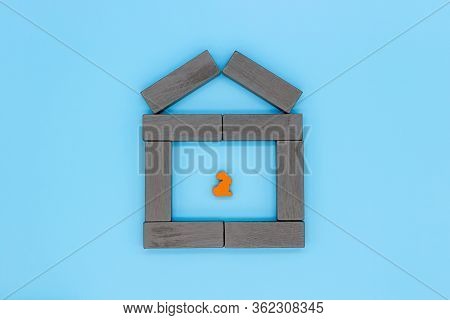 The Concept Of Quarantine And Self-isolation, A Lonely Wooden Rabbit Sits Alone In A House