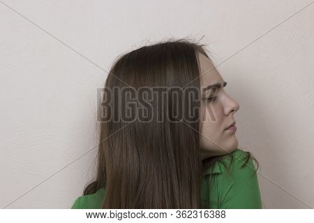 The Teenagers Girl Has A Very Bad Headache, She Closed Her Eyes And Writhes In Pain, Wry Face