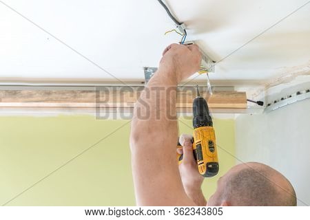 Fastening To The Wall Guide For Stretch Ceiling. Repairers Make Installation Of A Stretch Ceiling