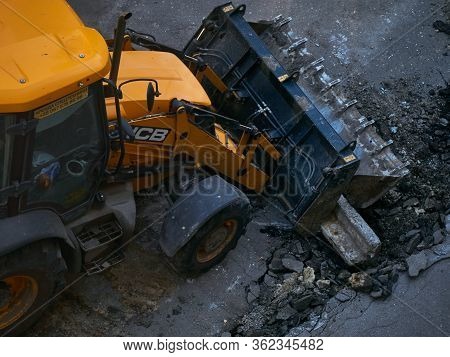 Kharkov, Ukraine - March 2020, Buldozer Remaking And Reconstructing Asphalt Road Near The Civil Buil