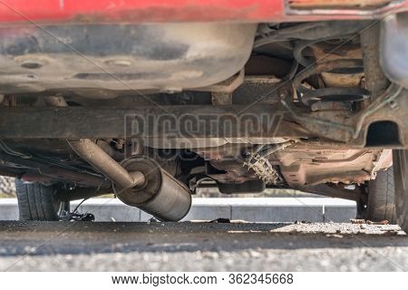 Car Exhaust, Muffler Fallen Down - View Of Rusty Chassis Of A Car
