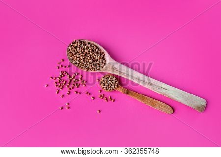 Wooden Spoon Of Roasted Buckwheat On Buckwheat Groat Jar Background, Gluten Free Ancient Grain For H