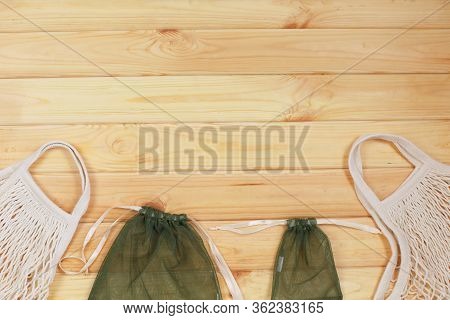 Two Kind Of Reusable Shopping Bags On Wooden Background.