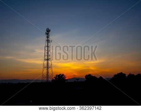 Electric Pylon At Sunset. Silhouette High Voltage Electric Tower On Sunset Time And Sky On Sunset Ti