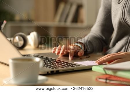 Close Up Of Student Girl Hands Using Touchpad On Laptop Studying At Night