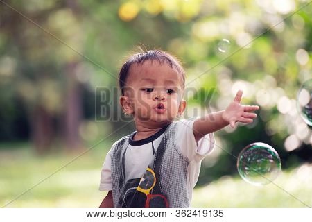 Asian Poor Children Playing Bubble In Nature Background.close Up Headshot Elementary Boy Happy Fun I