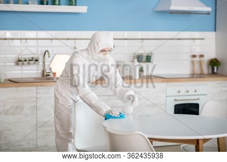 Woman In White Workwear Doing Disinfection At Home