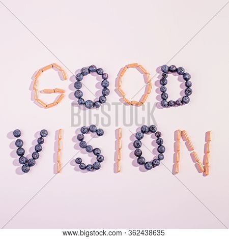 Vitamins And Supplements For Healthy Eyes On Pink Background. How To Maintain Good Vision Concept. B