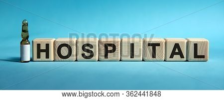 Hospital - Text On Cubes. Drug In Ambula To Reduce Disease Symptoms On A Blue Background