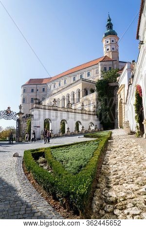Mikulov, Czech Republic - October 13 2019: People Walk On Streets With Mikulov Castle In Background