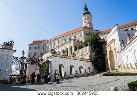 Mikulov, Czech Republic - October 13 2019: People Walk On Streets With Mikulov Castle In Background
