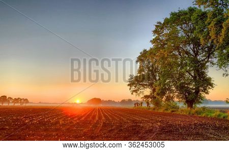 Dramatic And Colorful Sunrise Sky. Dramatic And Colorful Sunrise Or Sunset Sky Over A Grassy Green F