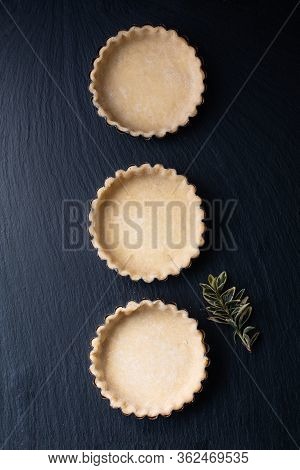 Food Concept Homemade Emty Pie Crust For Organic Lemon, Lime Tarts Or Mini Pie On Black Slate Stone