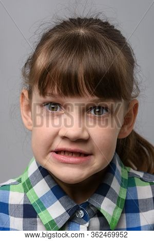 Portrait Of An Evil Ten-year-old Girl Of European Appearance, Close-up