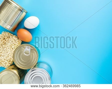 Tin Cans, Macaroni, Eggs On A Blue Background, Copispace, Mock Up. Stocks Of Fast Food And Long-term